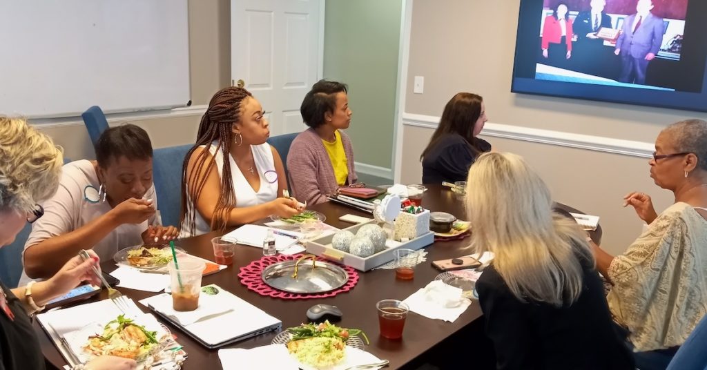 Women entrepreneurs meeting and eat lunch at Her Workspace in Alpharetta, Georgia